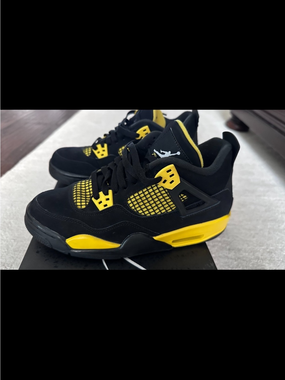 Nike Air Jordan 4 Retro Thunder (GS) in the iconic Black/Tour Yellow colorway